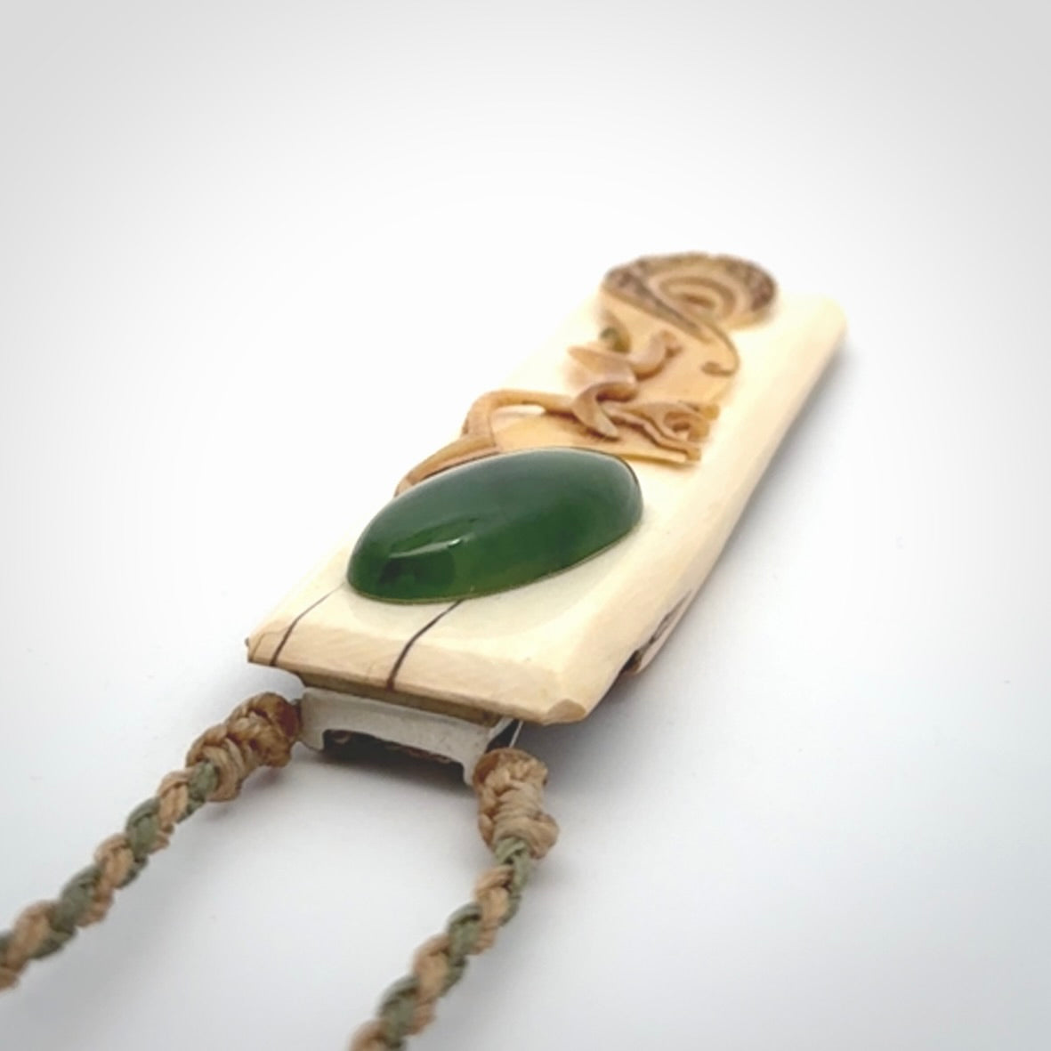 A beautiful, large toki with manaia pendant handmade from woolly mammoth tusk with Jade insert.