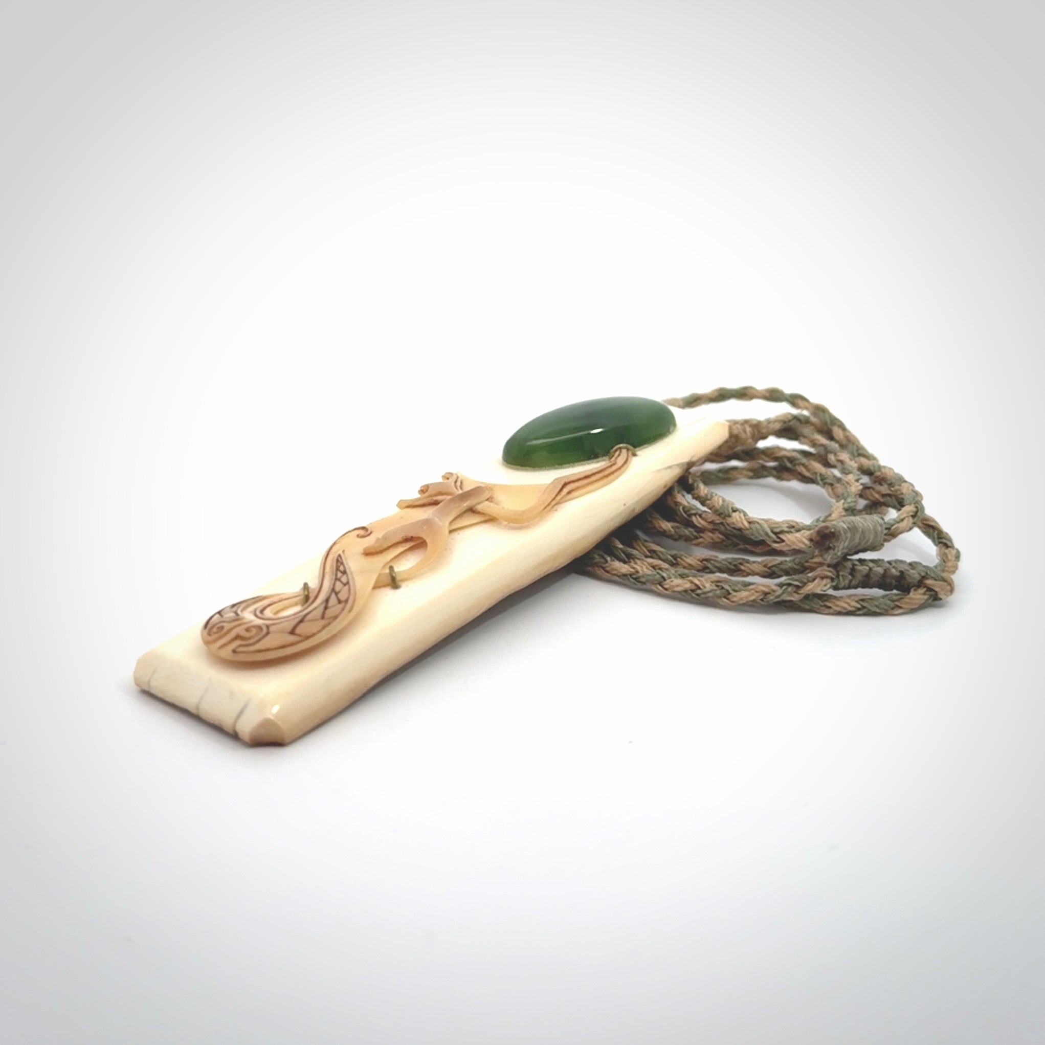 A beautiful, large toki with manaia pendant handmade from woolly mammoth tusk with Jade insert.