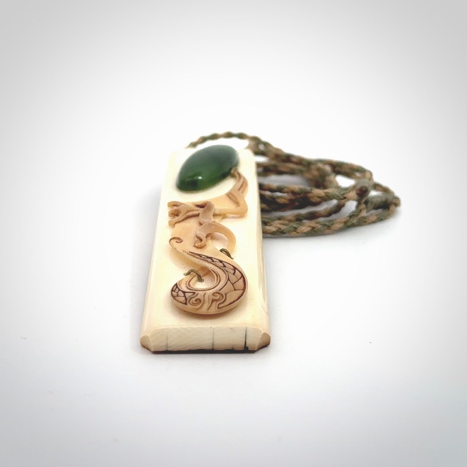 A beautiful, large toki with manaia pendant handmade from woolly mammoth tusk with Jade insert.