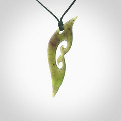 This photo shows a contemporary koru pendant carved from New Zealand Jade. The artist, Shaun Gardiner, has carved this beautifully. We provide this piece with an adjustable green coloured cord. This is a fantastic work of art, we have one only.