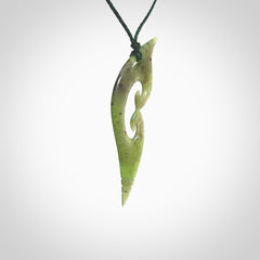 This photo shows a contemporary koru pendant carved from New Zealand Jade. The artist, Shaun Gardiner, has carved this beautifully. We provide this piece with an adjustable green coloured cord. This is a fantastic work of art, we have one only.