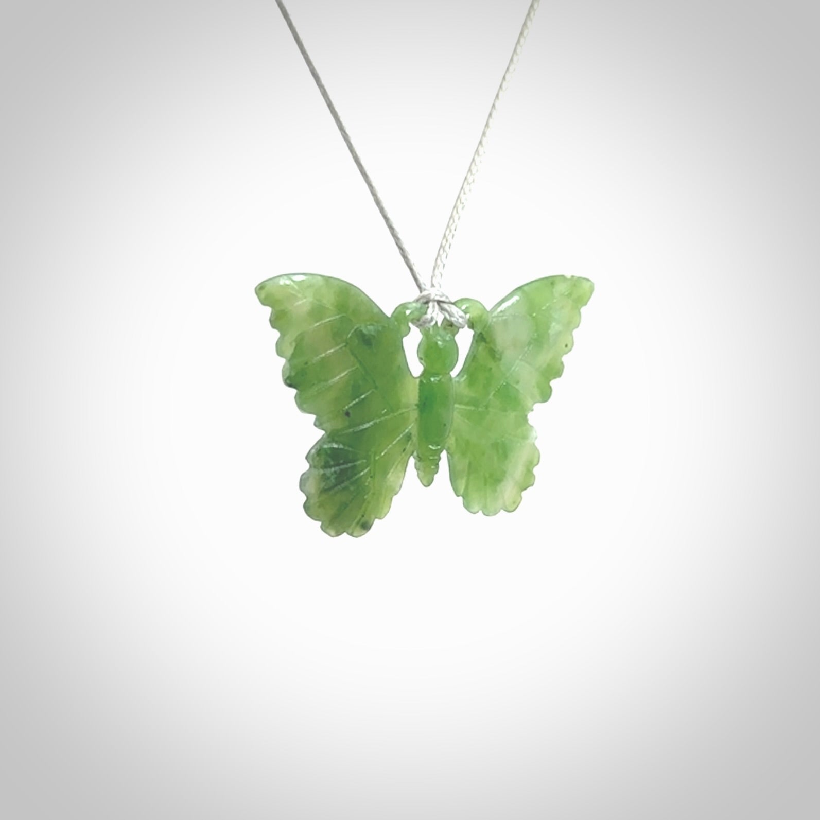 Large Butterfly design pendant carved in nephrite jade. Real jade jewellery for sale online with NZ Pacific. Large butterfly pendant hand made in Jade, provided with adjustable cord and packaged in a woven kete pouch.