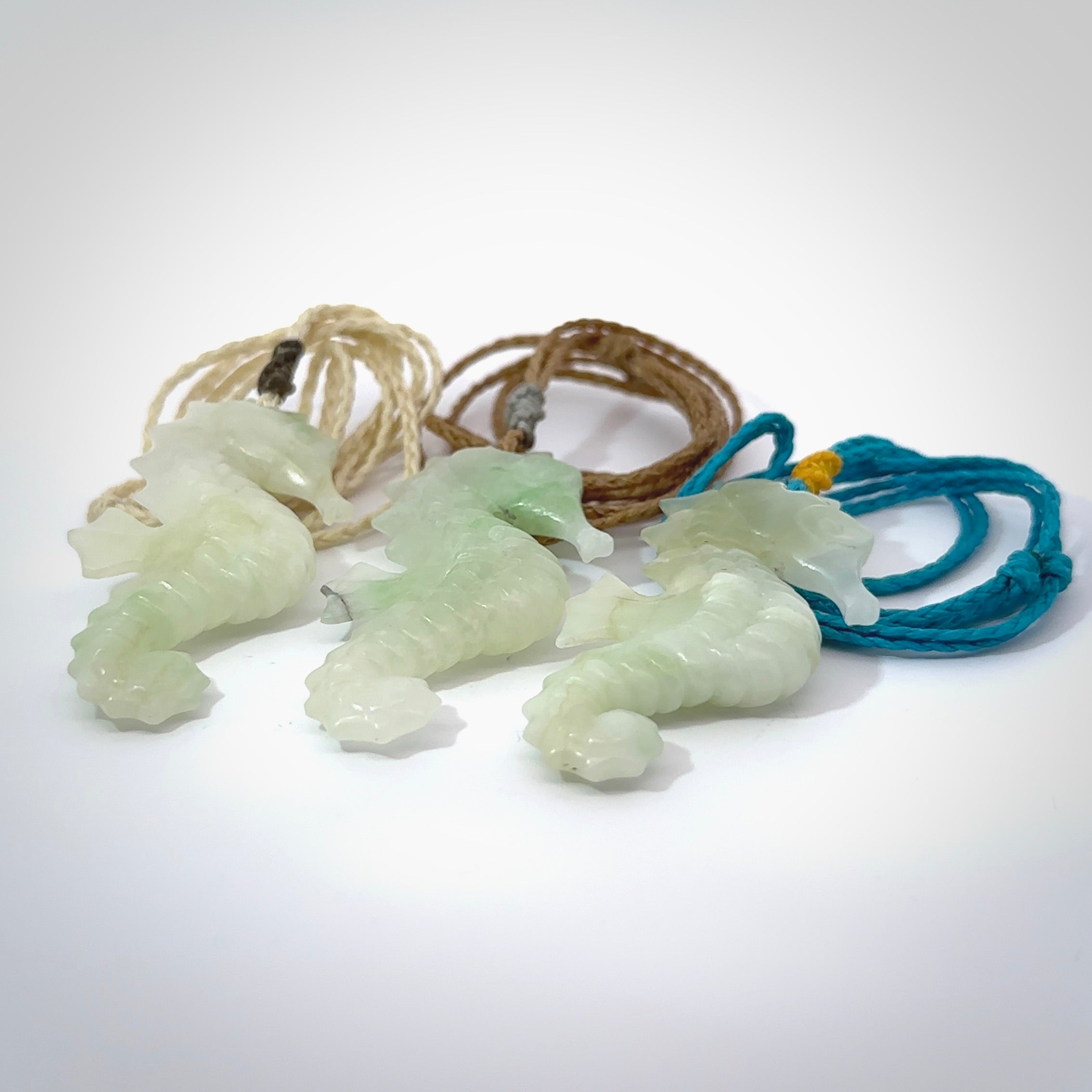 A hand carved Jadeite seahorse pendant. We have carved this from beautiful jadeite and we bind them with our hand-plaited cords. The cords are a waxed polyester so they are durable and strong. We ship these worldwide with express courier anywhere in the world.