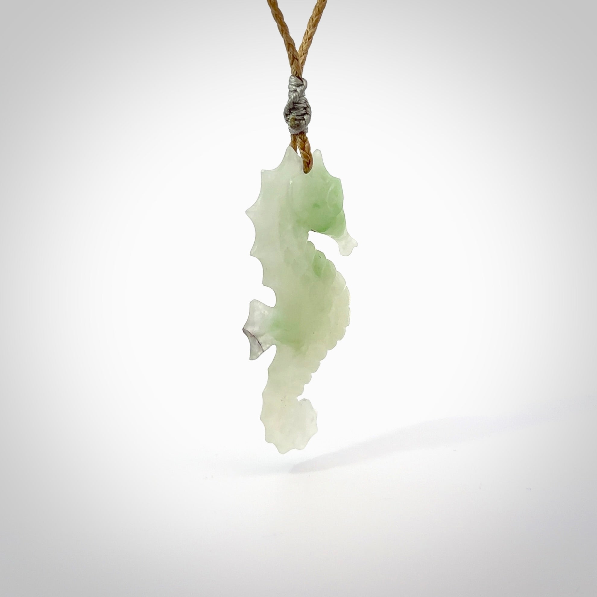 A hand carved Jadeite seahorse pendant. We have carved this from beautiful jadeite and we bind them with our hand-plaited cords. The cords are a waxed polyester so they are durable and strong. We ship these worldwide with express courier anywhere in the world.