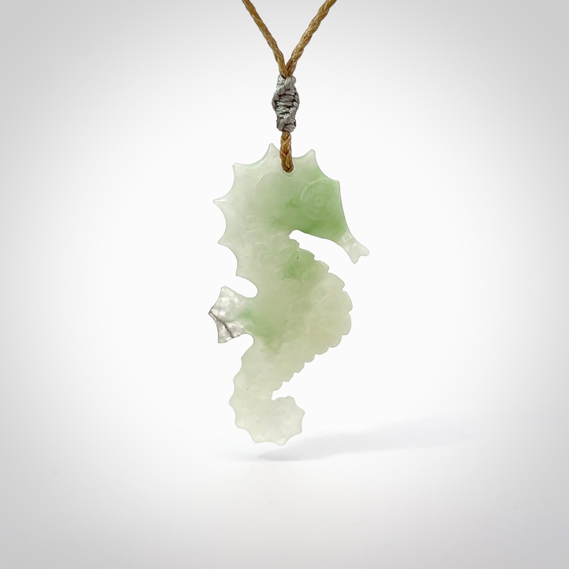 A hand carved Jadeite seahorse pendant. We have carved this from beautiful jadeite and we bind them with our hand-plaited cords. The cords are a waxed polyester so they are durable and strong. We ship these worldwide with express courier anywhere in the world.