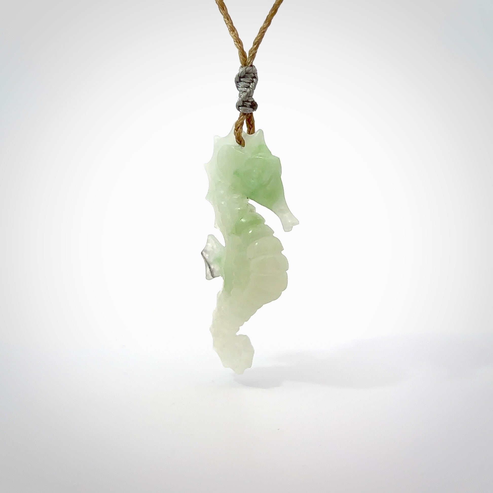 A hand carved Jadeite seahorse pendant. We have carved this from beautiful jadeite and we bind them with our hand-plaited cords. The cords are a waxed polyester so they are durable and strong. We ship these worldwide with express courier anywhere in the world.