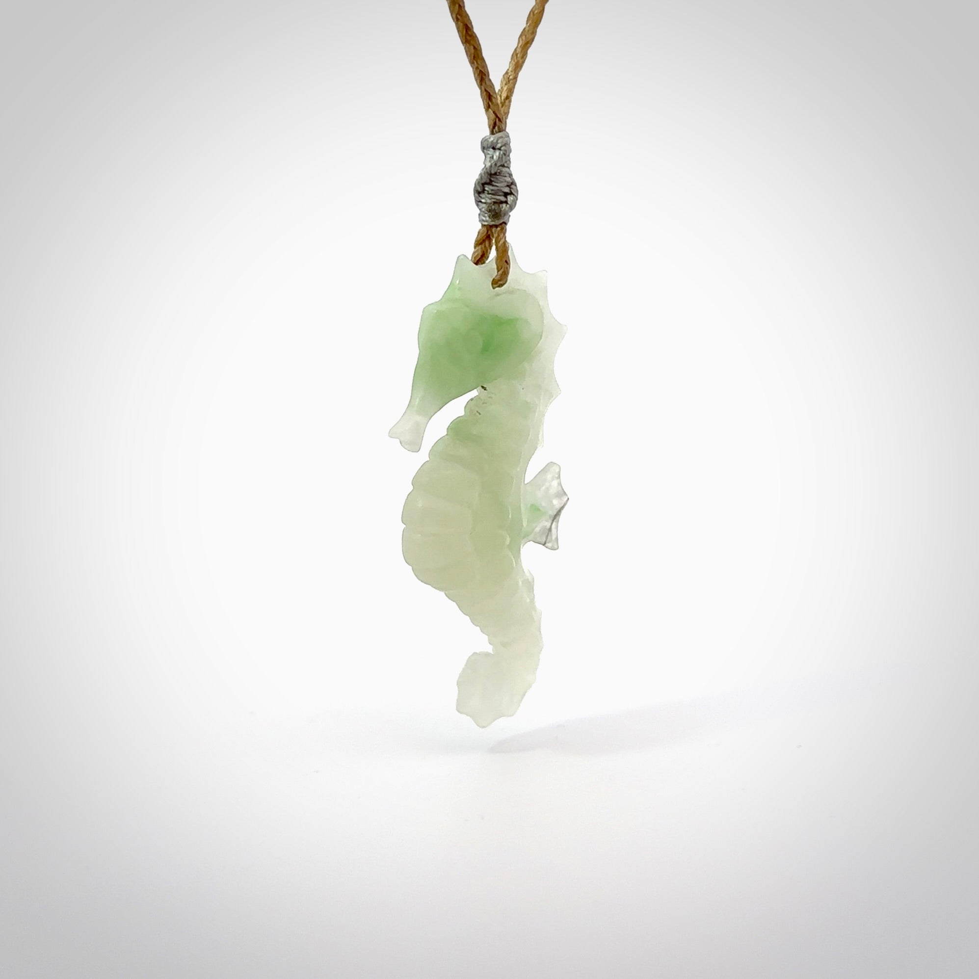 A hand carved Jadeite seahorse pendant. We have carved this from beautiful jadeite and we bind them with our hand-plaited cords. The cords are a waxed polyester so they are durable and strong. We ship these worldwide with express courier anywhere in the world.