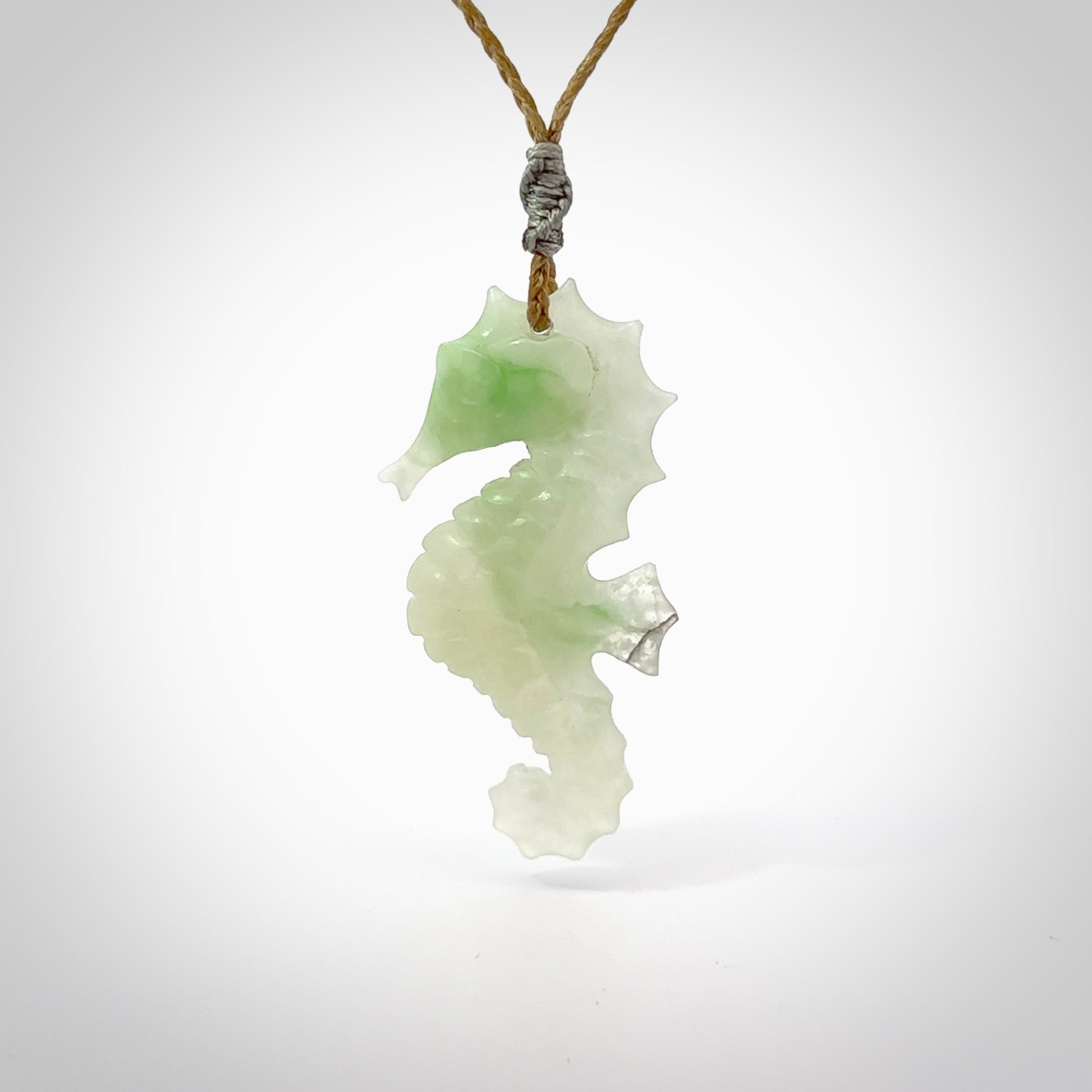 A hand carved Jadeite seahorse pendant. We have carved this from beautiful jadeite and we bind them with our hand-plaited cords. The cords are a waxed polyester so they are durable and strong. We ship these worldwide with express courier anywhere in the world.