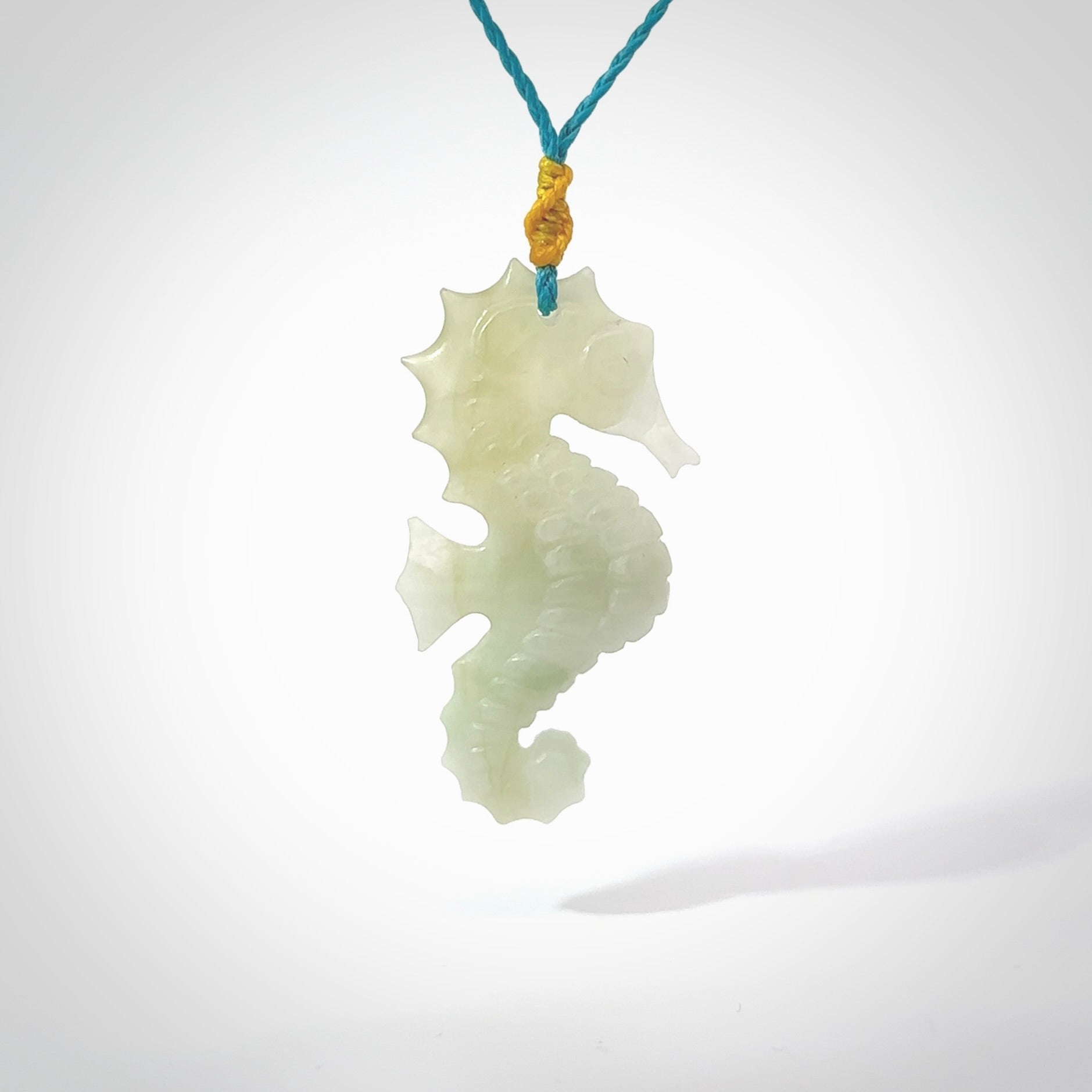 A hand carved Jadeite seahorse pendant. We have carved this from beautiful jadeite and we bind them with our hand-plaited cords. The cords are a waxed polyester so they are durable and strong. We ship these worldwide with express courier anywhere in the world.