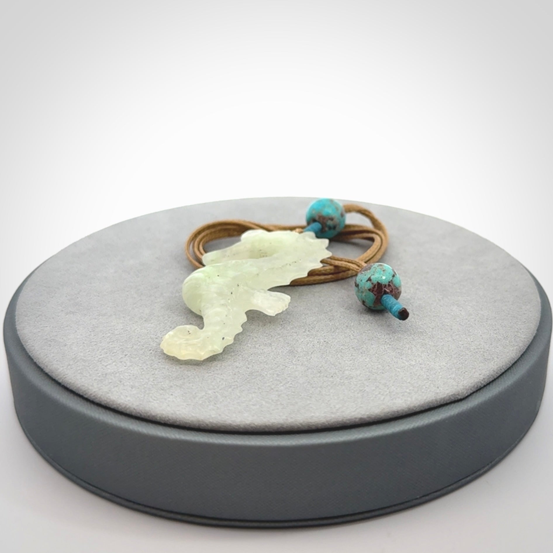 A hand carved Jadeite seahorse pendant. We have carved this from beautiful jadeite and we bind them with our adjustable cords.