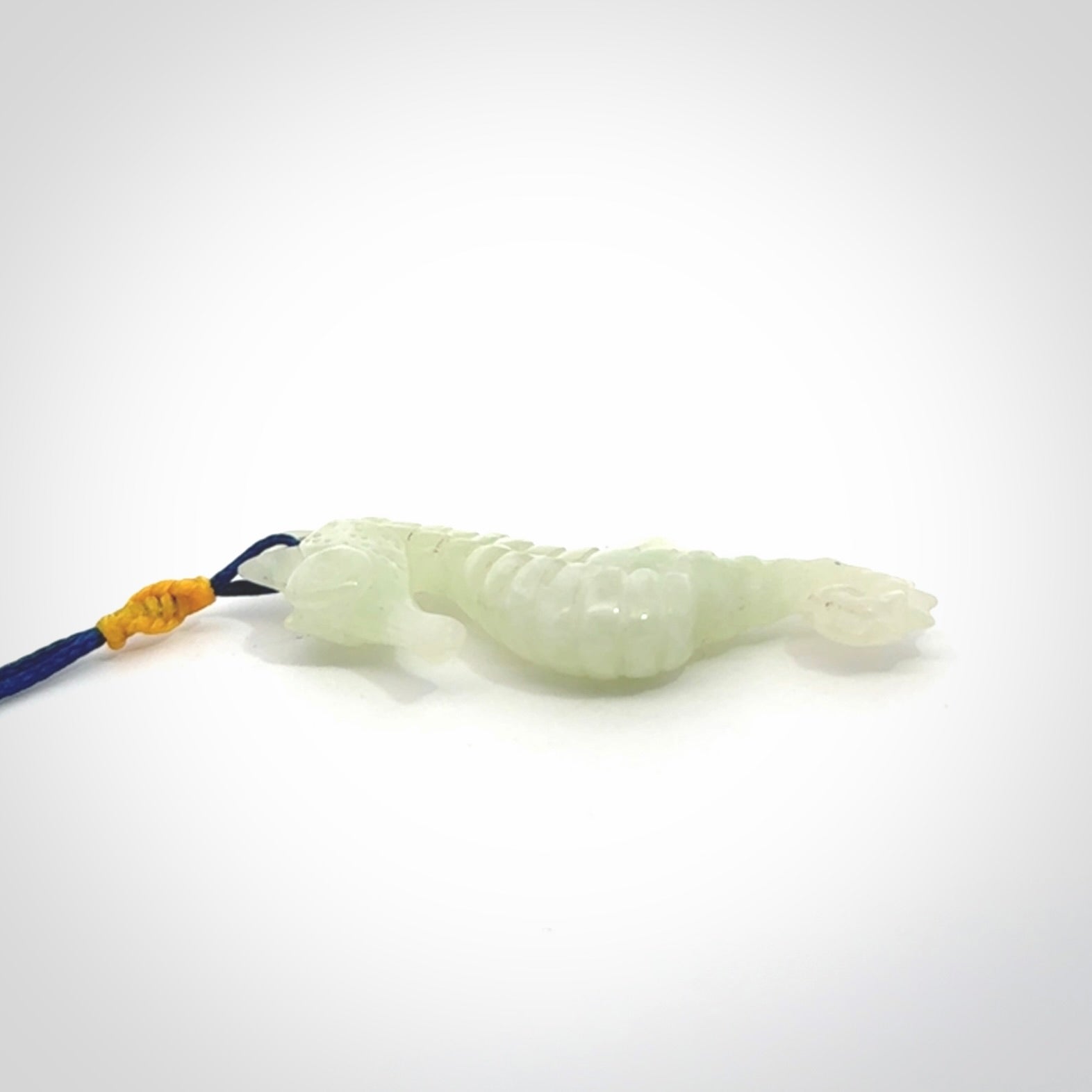 A hand carved Jadeite seahorse pendant. We have carved this from beautiful jadeite and we bind them with our Pacific Blue cords.
