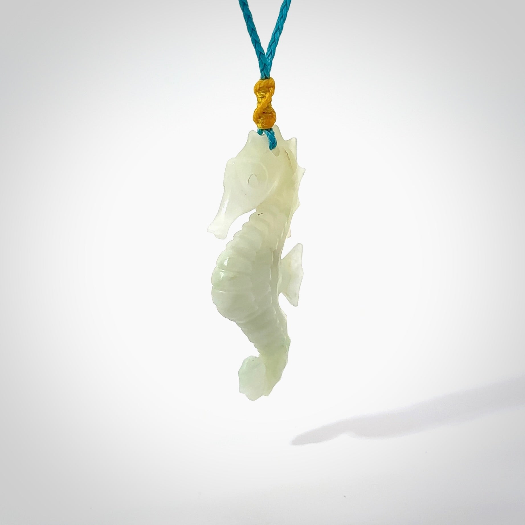 A hand carved Jadeite seahorse pendant. We have carved this from beautiful jadeite and we bind them with our hand-plaited cords. The cords are a waxed polyester so they are durable and strong. We ship these worldwide with express courier anywhere in the world.