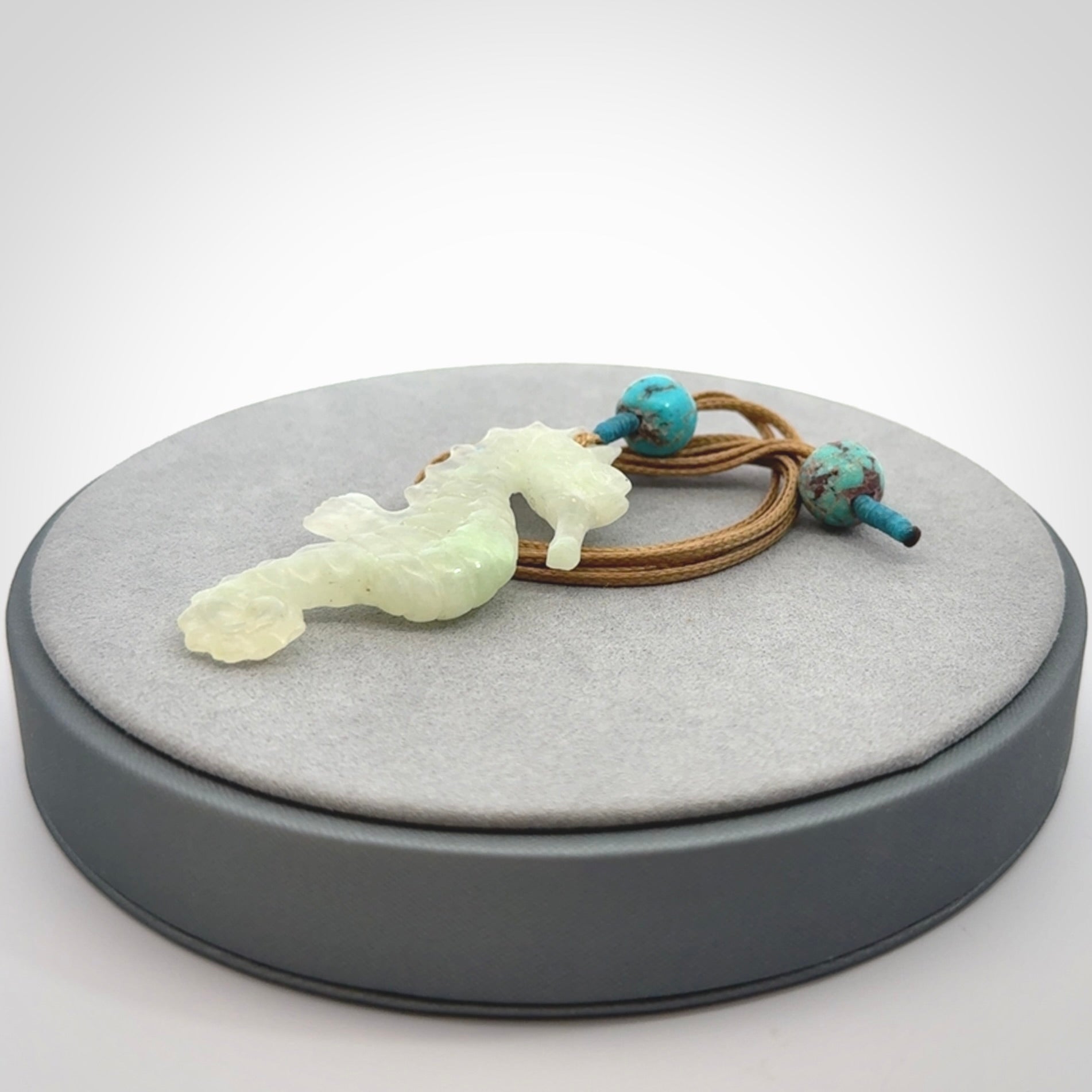 A hand carved Jadeite seahorse pendant. We have carved this from beautiful jadeite and we bind them with our adjustable cords.