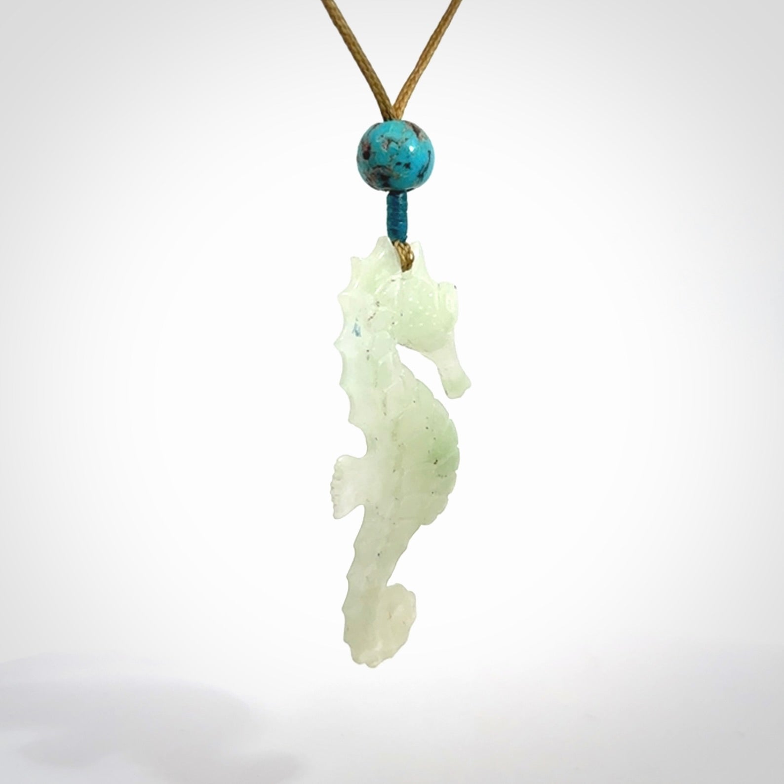 A hand carved Jadeite seahorse pendant. We have carved this from beautiful jadeite and we bind them with our adjustable cords.