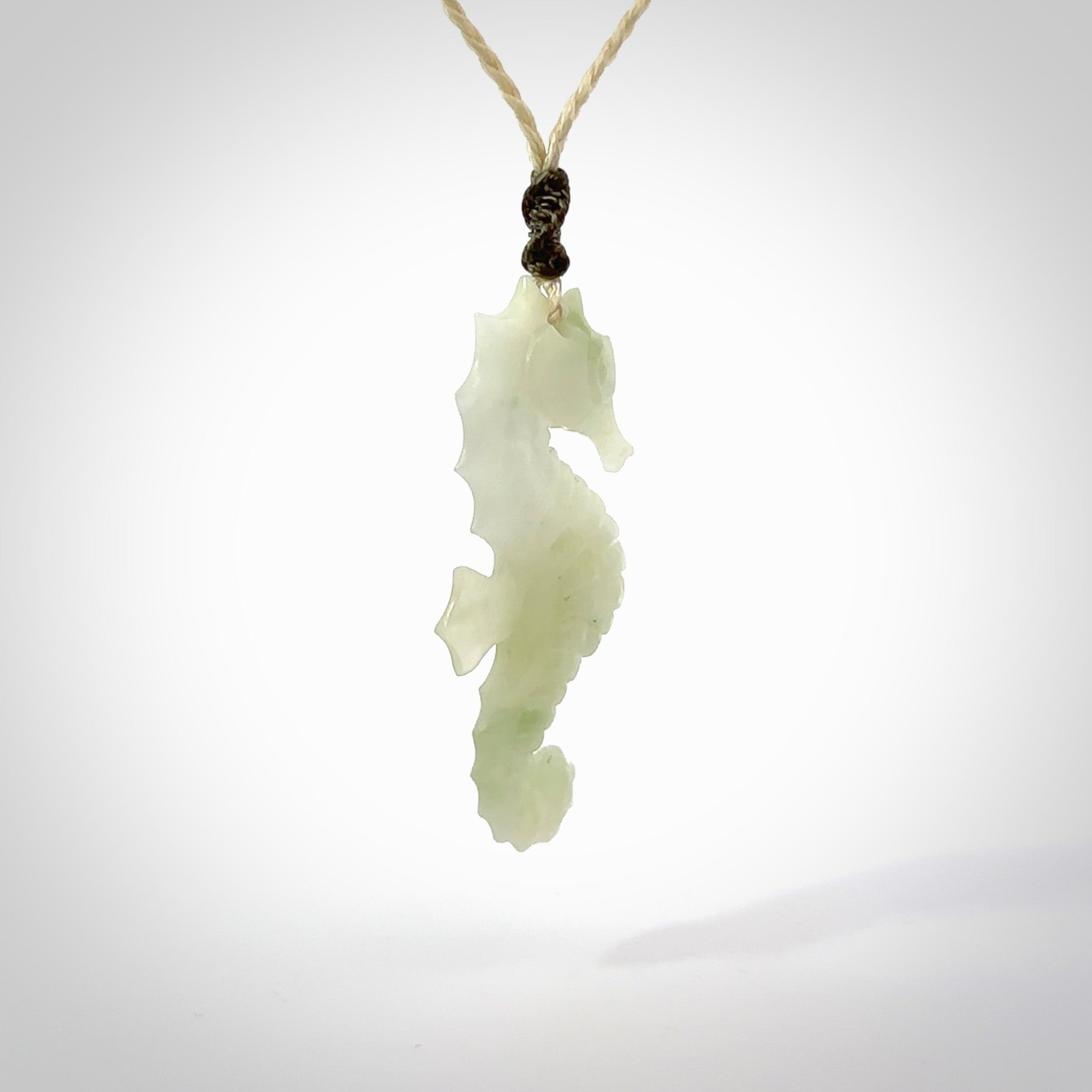 A hand carved Jadeite seahorse pendant. We have carved this from beautiful jadeite and we bind them with our hand-plaited cords. The cords are a waxed polyester so they are durable and strong. We ship these worldwide with express courier anywhere in the world.