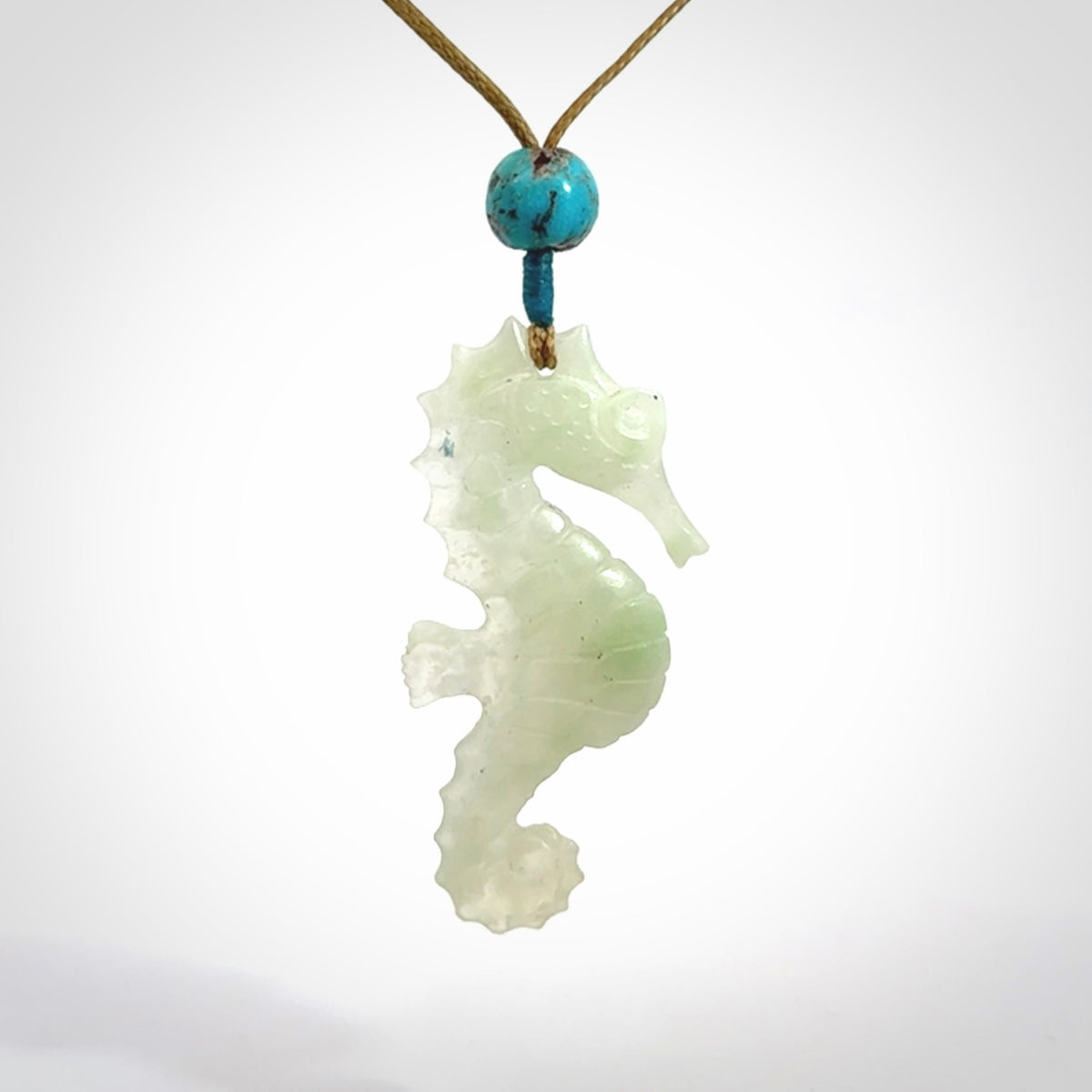 A hand carved Jadeite seahorse pendant. We have carved this from beautiful jadeite and we bind them with our adjustable cords.