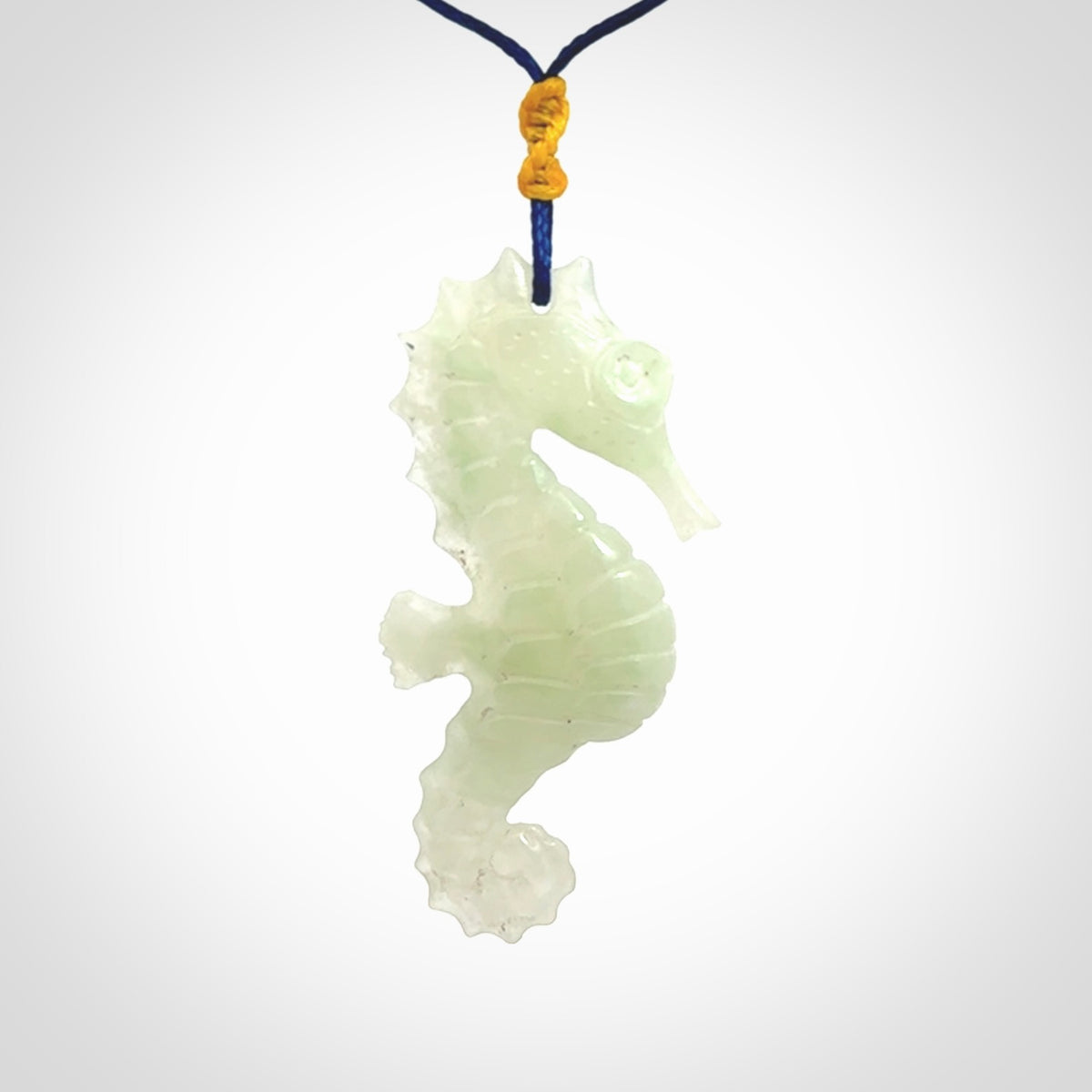A hand carved Jadeite seahorse pendant. We have carved this from beautiful jadeite and we bind them with our Pacific Blue cords.
