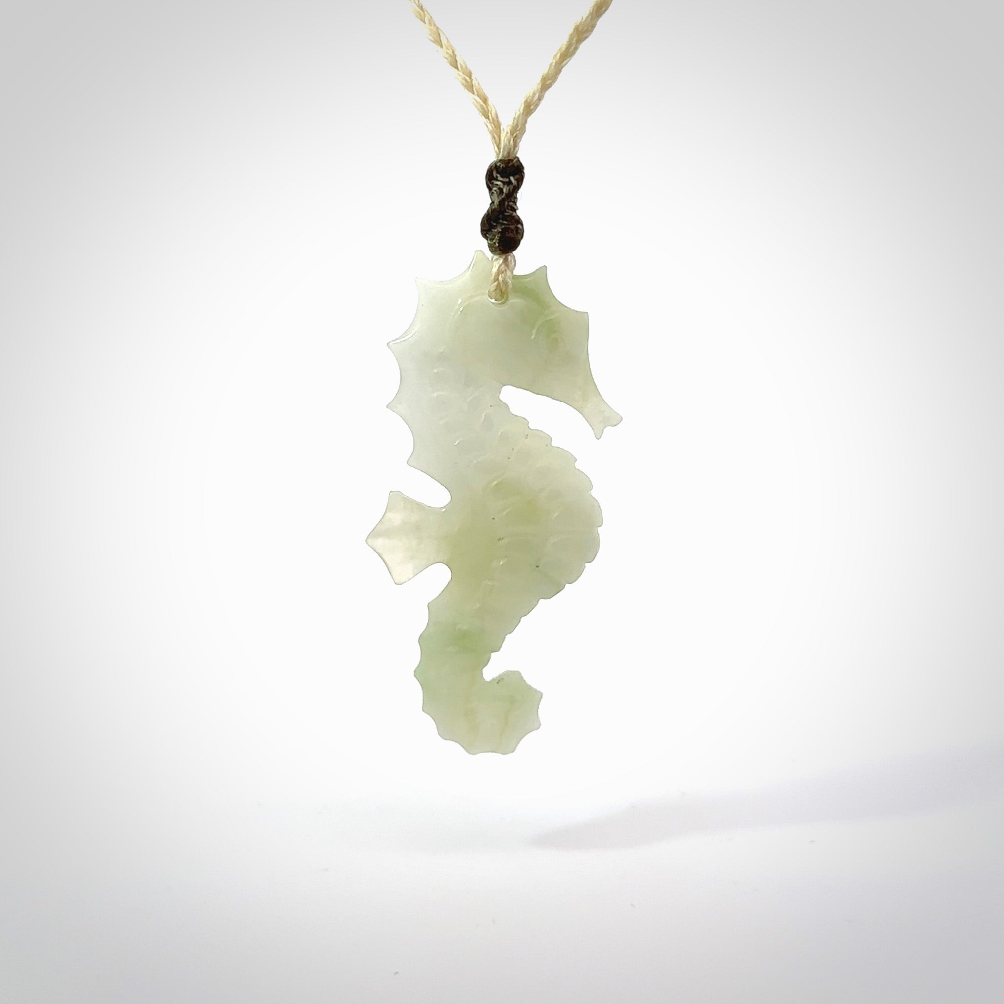A hand carved Jadeite seahorse pendant. We have carved this from beautiful jadeite and we bind them with our hand-plaited cords. The cords are a waxed polyester so they are durable and strong. We ship these worldwide with express courier anywhere in the world.