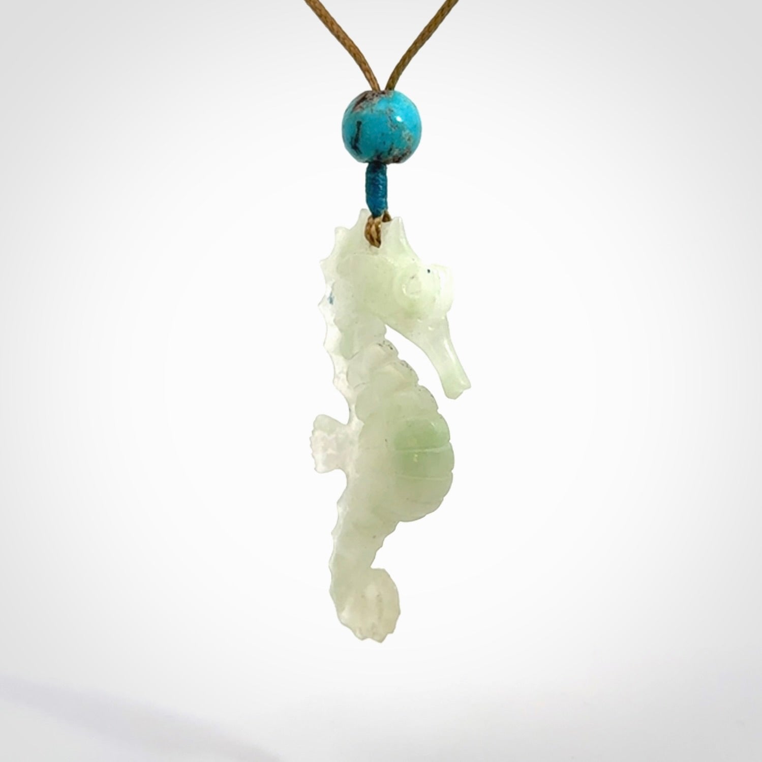 A hand carved Jadeite seahorse pendant. We have carved this from beautiful jadeite and we bind them with our adjustable cords.
