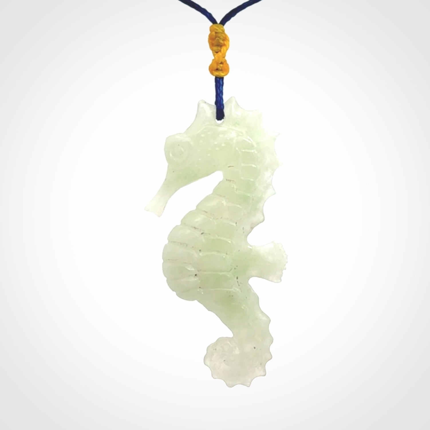 A hand carved Jadeite seahorse pendant. We have carved this from beautiful jadeite and we bind them with our Pacific Blue cords.