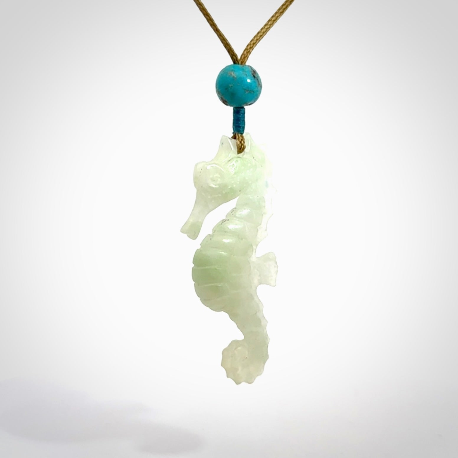 A hand carved Jadeite seahorse pendant. We have carved this from beautiful jadeite and we bind them with our adjustable cords.