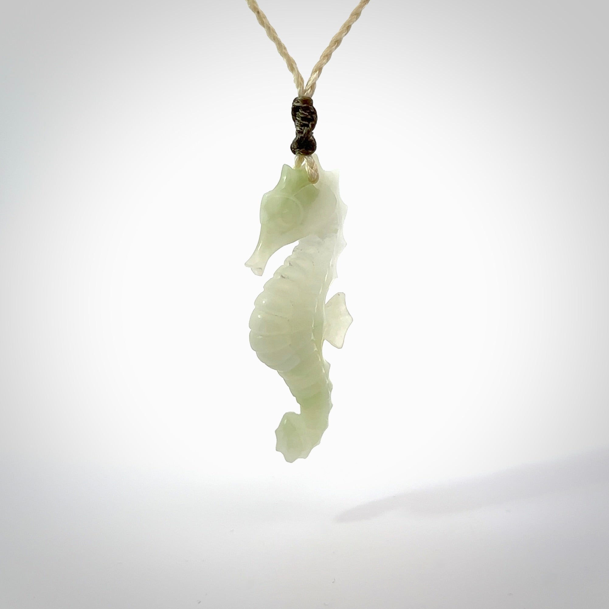 A hand carved Jadeite seahorse pendant. We have carved this from beautiful jadeite and we bind them with our hand-plaited cords. The cords are a waxed polyester so they are durable and strong. We ship these worldwide with express courier anywhere in the world.