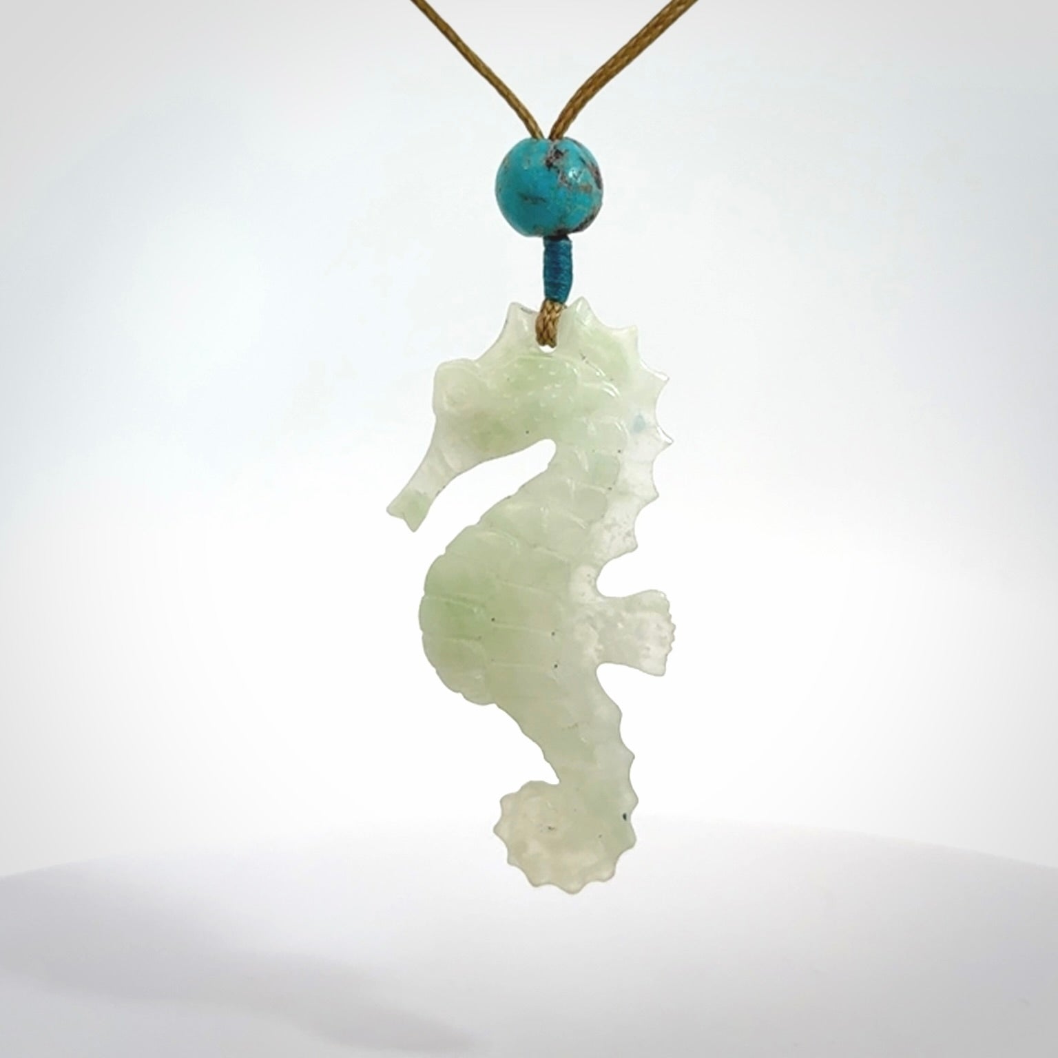 A hand carved Jadeite seahorse pendant. We have carved this from beautiful jadeite and we bind them with our adjustable cords.
