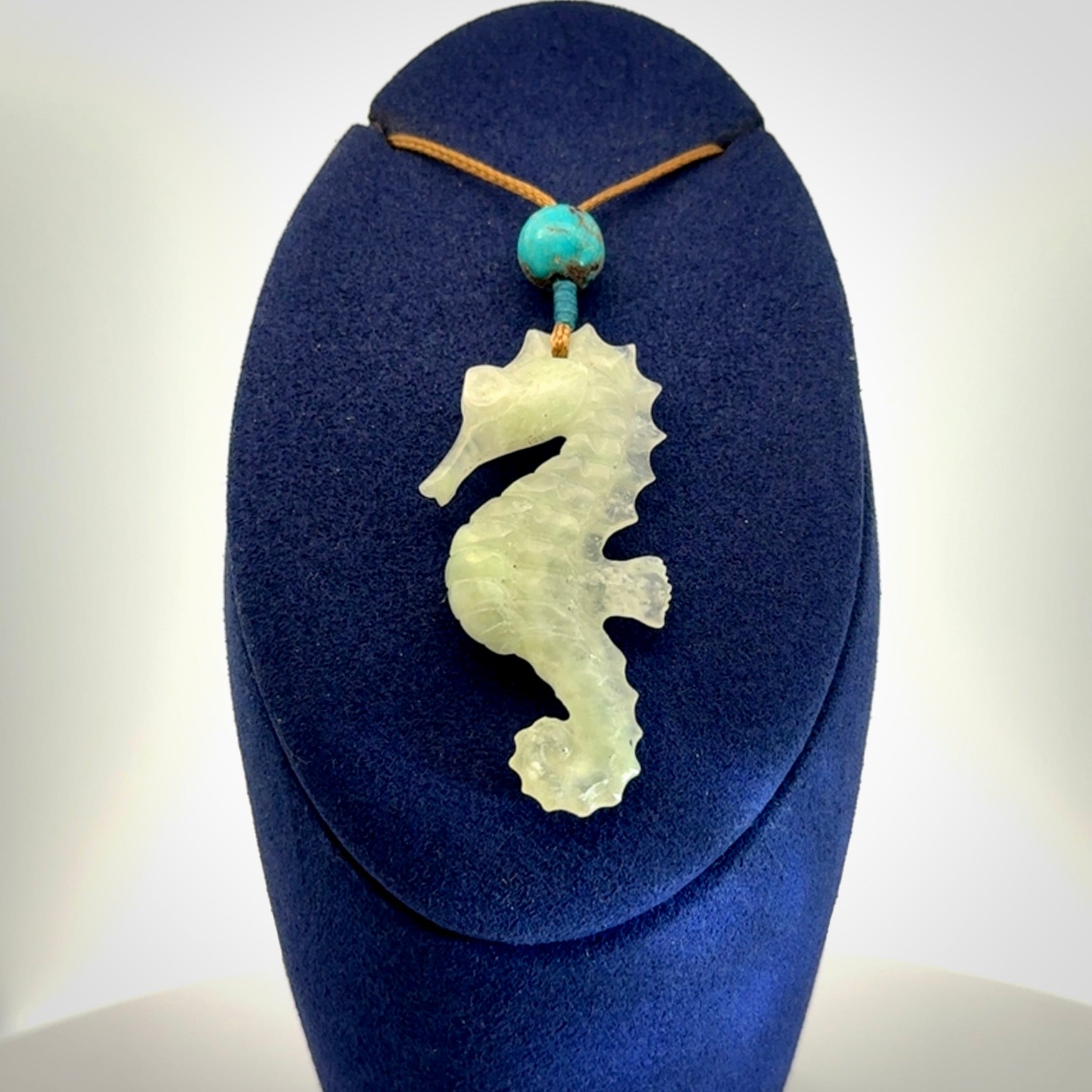 A hand carved Jadeite seahorse pendant. We have carved this from beautiful jadeite and we bind them with our adjustable cords.