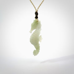 A hand carved Jadeite seahorse pendant. We have carved this from beautiful jadeite and we bind them with our hand-plaited cords. The cords are a waxed polyester so they are durable and strong. We ship these worldwide with express courier anywhere in the world.