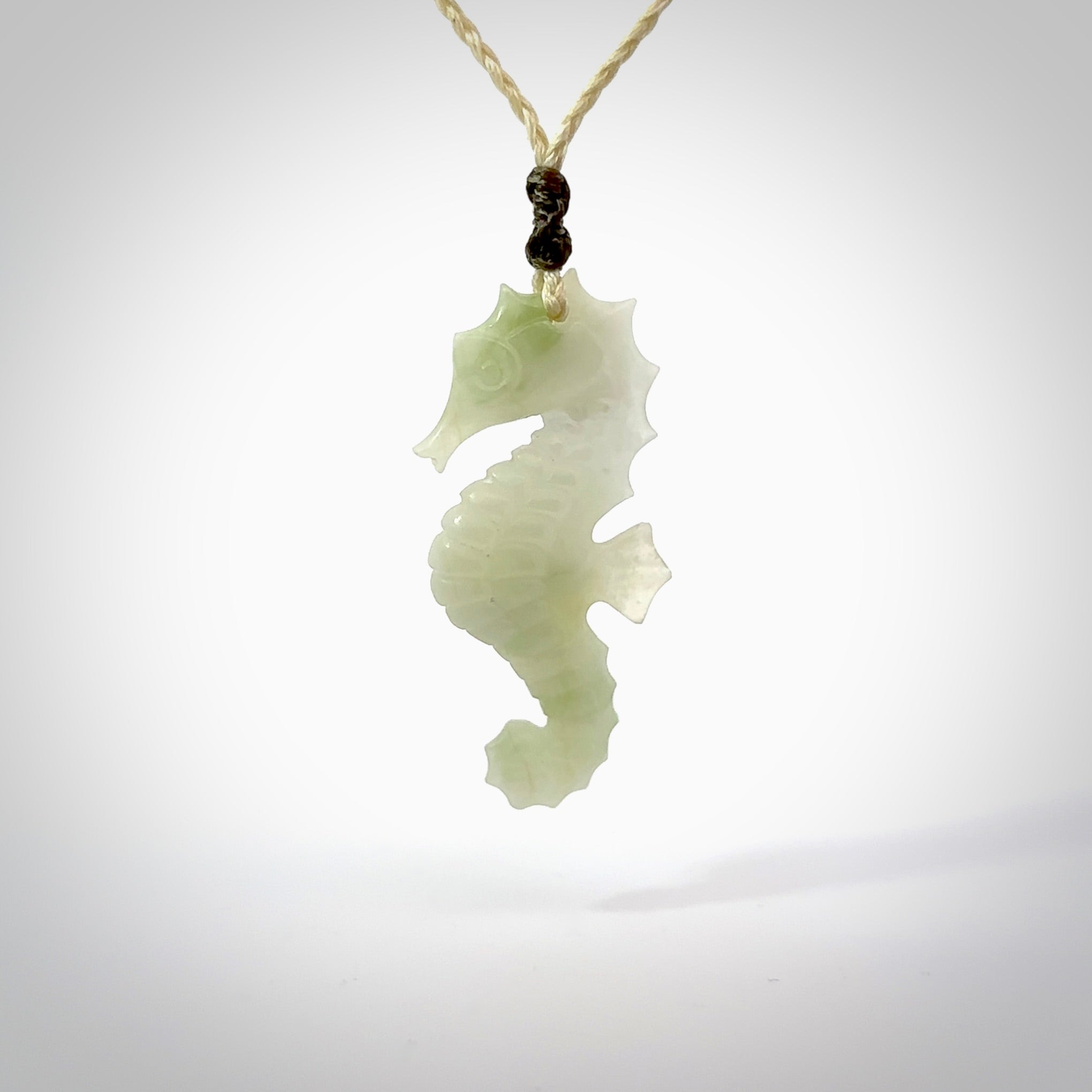 A hand carved Jadeite seahorse pendant. We have carved this from beautiful jadeite and we bind them with our hand-plaited cords. The cords are a waxed polyester so they are durable and strong. We ship these worldwide with express courier anywhere in the world.