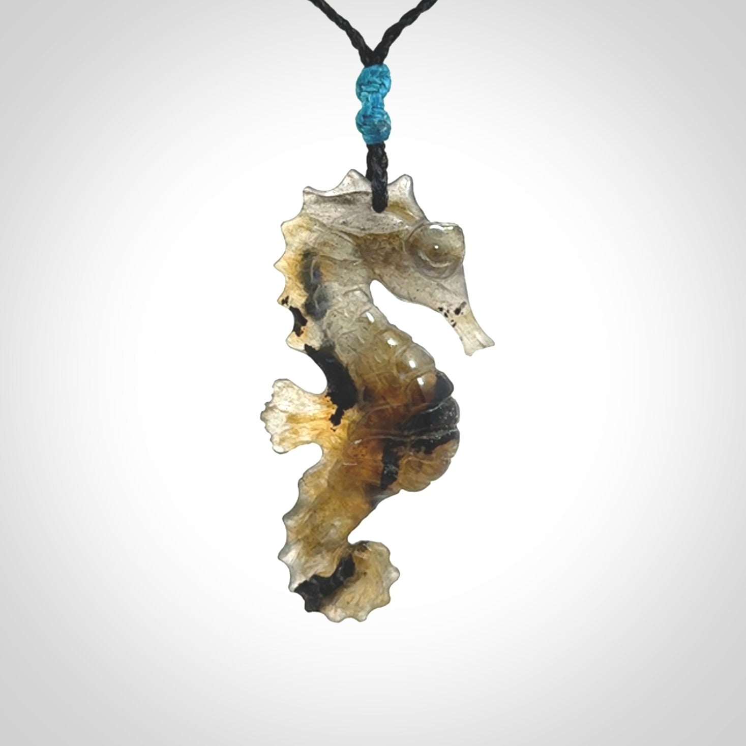 A hand carved labradorite seahorse pendant. We have carved this from beautiful labradorite and we bind them with our hand-plaited cords. The cords are a waxed polyester so they are durable and strong. We ship these worldwide with express courier anywhere in the world.