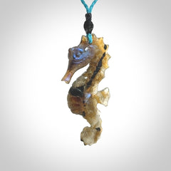 A hand carved labradorite seahorse pendant. We have carved this from beautiful labradorite and we bind them with our hand-plaited cords. The cords are a waxed polyester so they are durable and strong. We ship these worldwide with express courier anywhere in the world.
