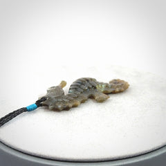 A hand carved labradorite seahorse pendant. We have carved this from beautiful labradorite and we bind them with our hand-plaited cords. The cords are a waxed polyester so they are durable and strong. We ship these worldwide with express courier anywhere in the world.