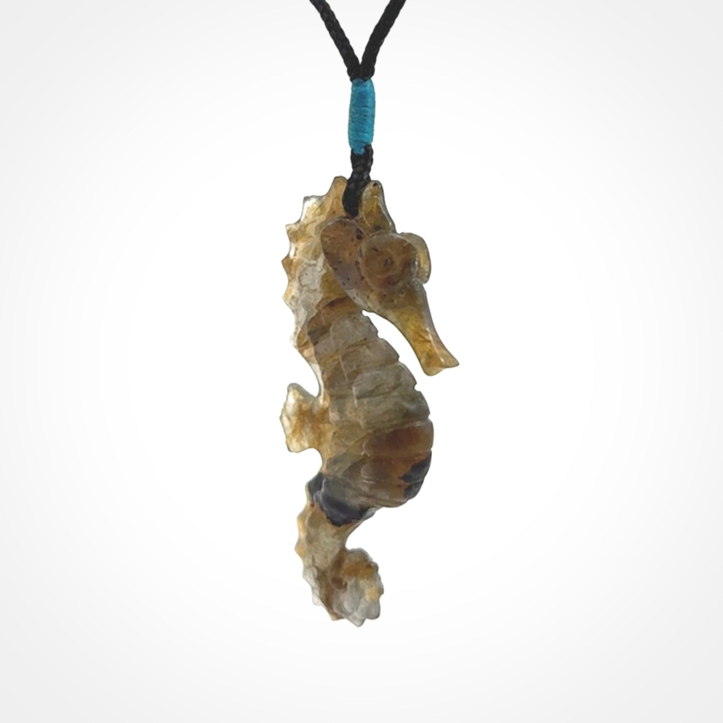 A hand carved labradorite seahorse pendant. We have carved this from beautiful labradorite and we bind them with our hand-plaited cords. The cords are a waxed polyester so they are durable and strong. We ship these worldwide with express courier anywhere in the world.