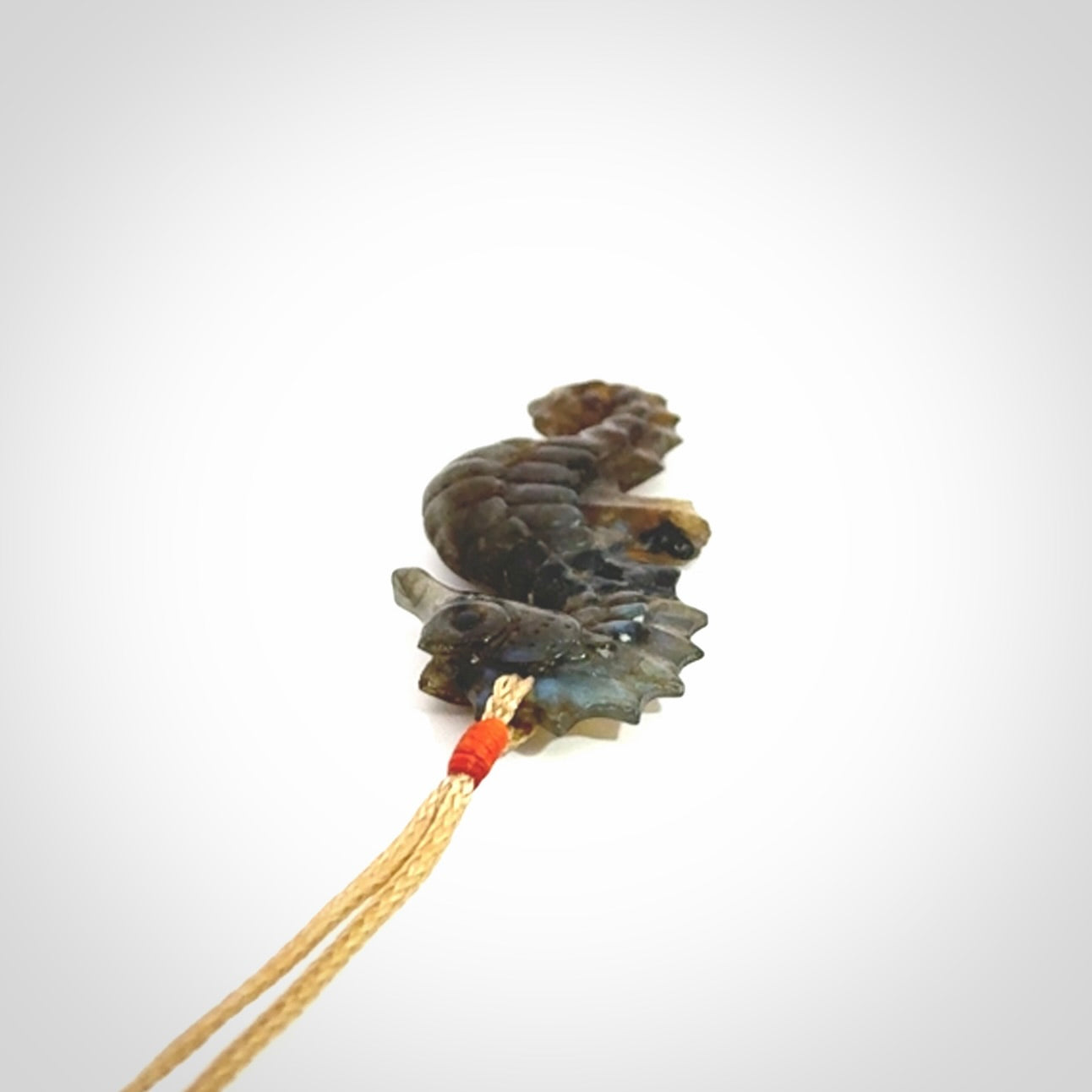 A hand carved labradorite seahorse pendant. We have carved this from beautiful labradorite and we bind them with our hand-plaited cords. The cords are a waxed polyester so they are durable and strong. We ship these worldwide with express courier anywhere in the world.