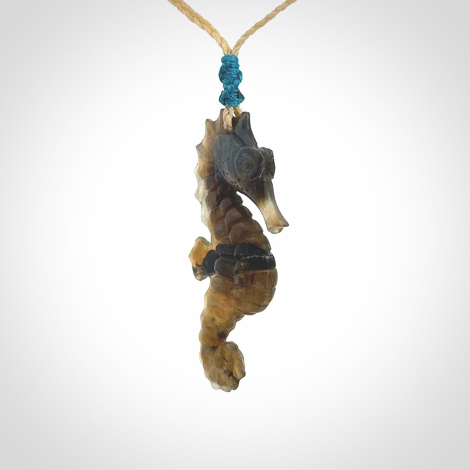 A hand carved labradorite seahorse pendant. We have carved this from beautiful labradorite and we bind them with our hand-plaited cords. The cords are a waxed polyester so they are durable and strong. We ship these worldwide with express courier anywhere in the world.