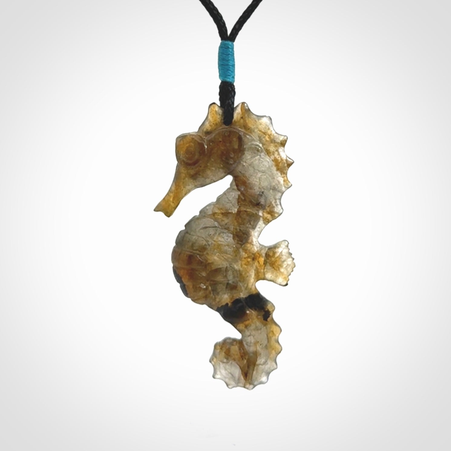 A hand carved labradorite seahorse pendant. We have carved this from beautiful labradorite and we bind them with our hand-plaited cords. The cords are a waxed polyester so they are durable and strong. We ship these worldwide with express courier anywhere in the world.