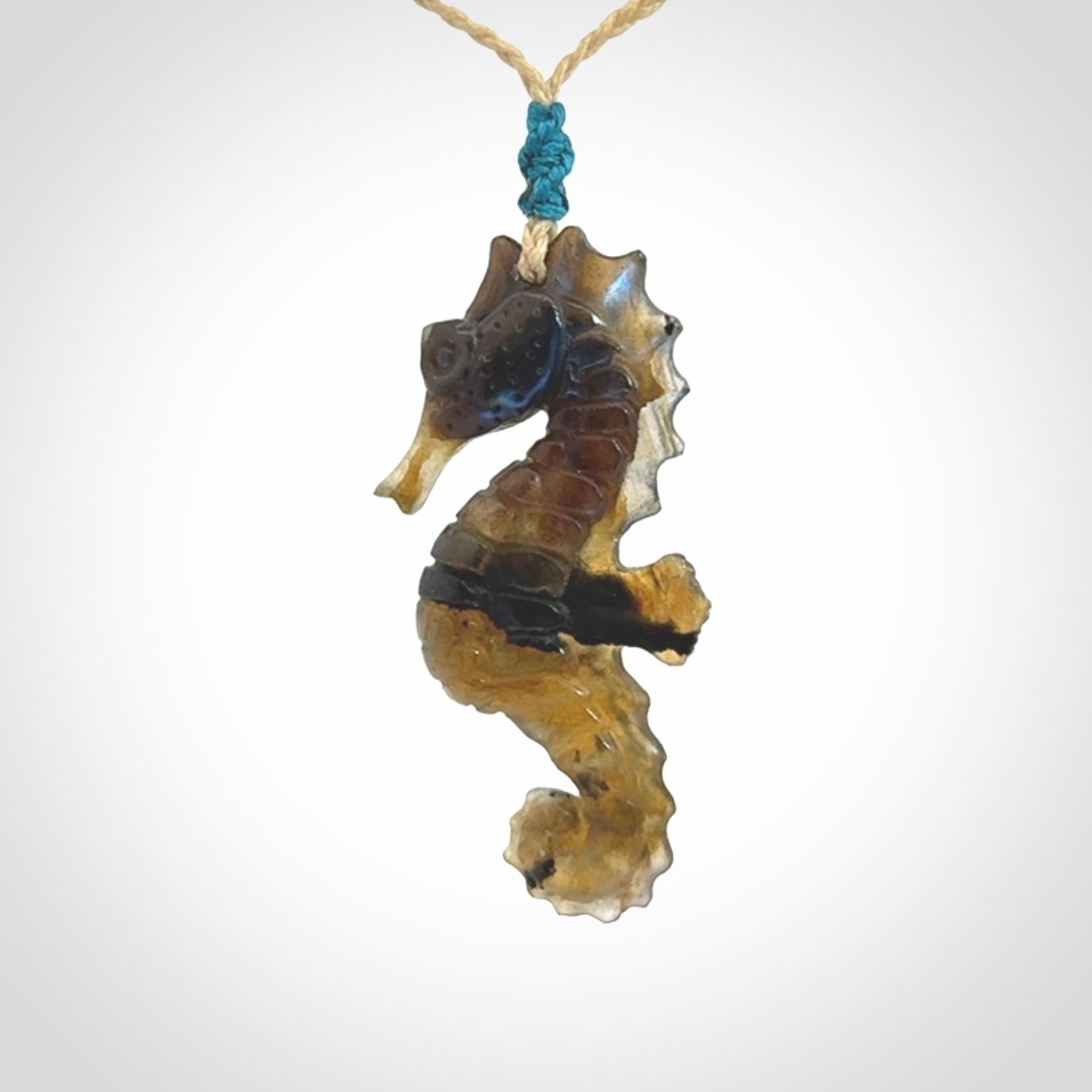A hand carved labradorite seahorse pendant. We have carved this from beautiful labradorite and we bind them with our hand-plaited cords. The cords are a waxed polyester so they are durable and strong. We ship these worldwide with express courier anywhere in the world.