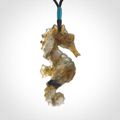 A hand carved labradorite seahorse pendant. We have carved this from beautiful labradorite and we bind them with our hand-plaited cords. The cords are a waxed polyester so they are durable and strong. We ship these worldwide with express courier anywhere in the world.