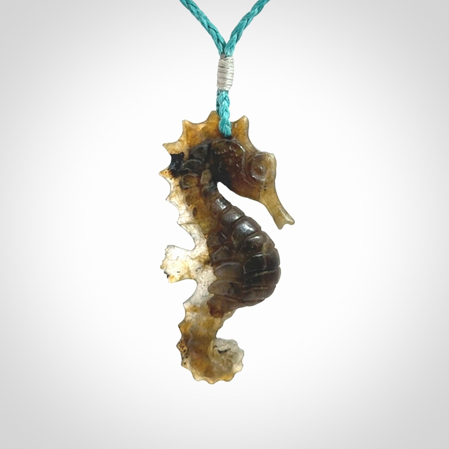 A hand carved labradorite seahorse pendant. We have carved this from beautiful labradorite and we bind them with our hand-plaited cords. The cords are a waxed polyester so they are durable and strong. We ship these worldwide with express courier anywhere in the world.