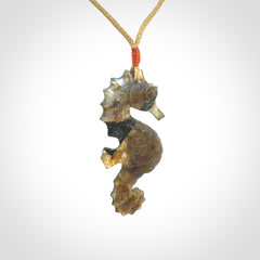 A hand carved labradorite seahorse pendant. We have carved this from beautiful labradorite and we bind them with our hand-plaited cords. The cords are a waxed polyester so they are durable and strong. We ship these worldwide with express courier anywhere in the world.