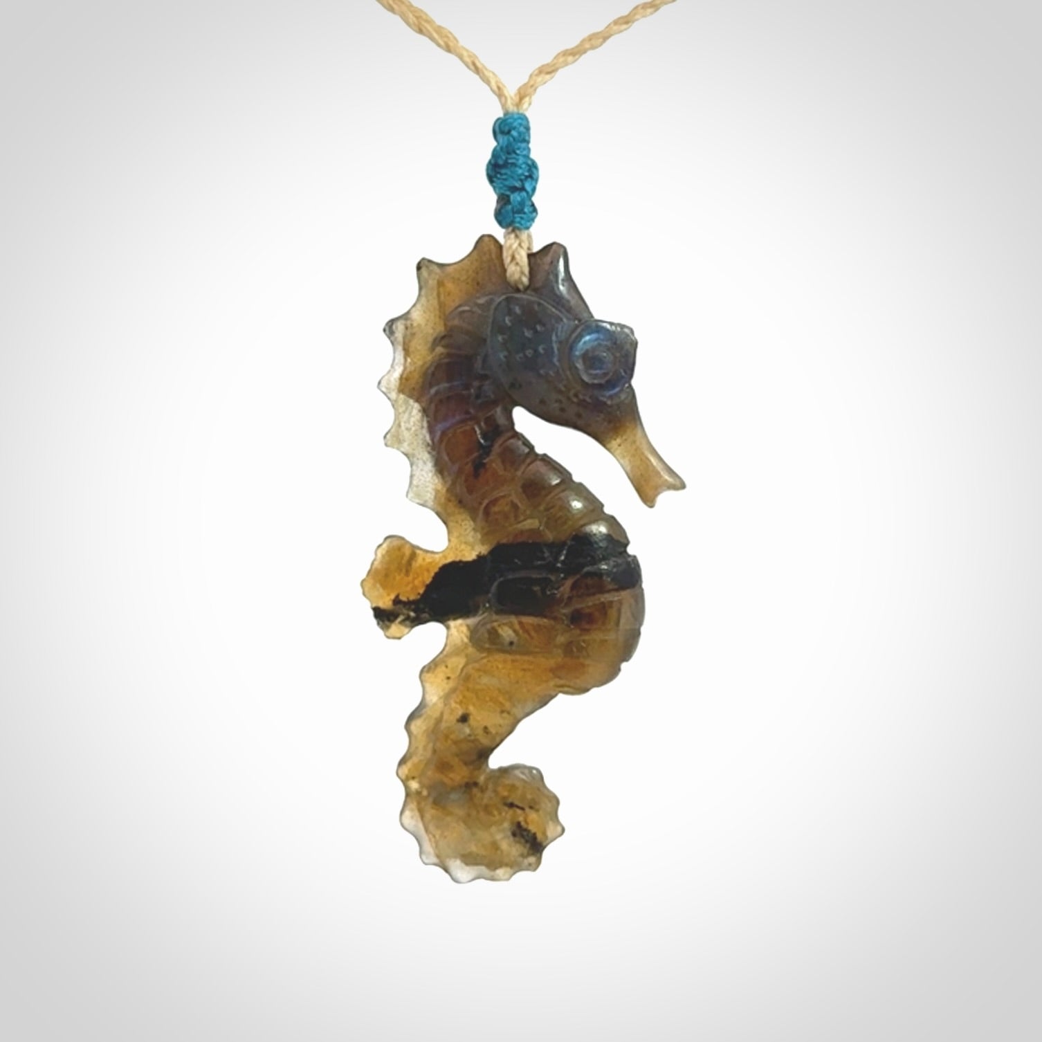 A hand carved labradorite seahorse pendant. We have carved this from beautiful labradorite and we bind them with our hand-plaited cords. The cords are a waxed polyester so they are durable and strong. We ship these worldwide with express courier anywhere in the world.