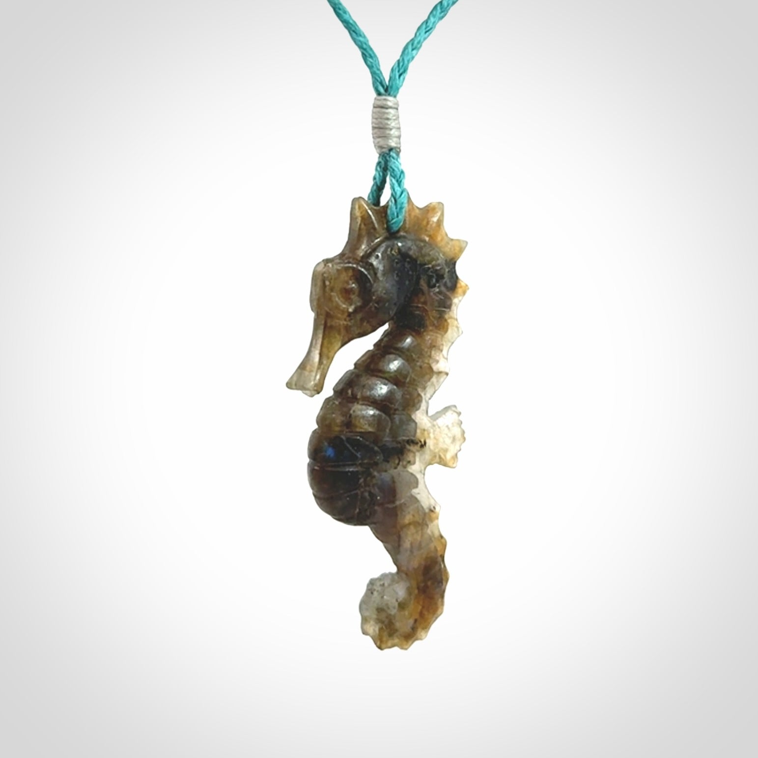 A hand carved labradorite seahorse pendant. We have carved this from beautiful labradorite and we bind them with our hand-plaited cords. The cords are a waxed polyester so they are durable and strong. We ship these worldwide with express courier anywhere in the world.