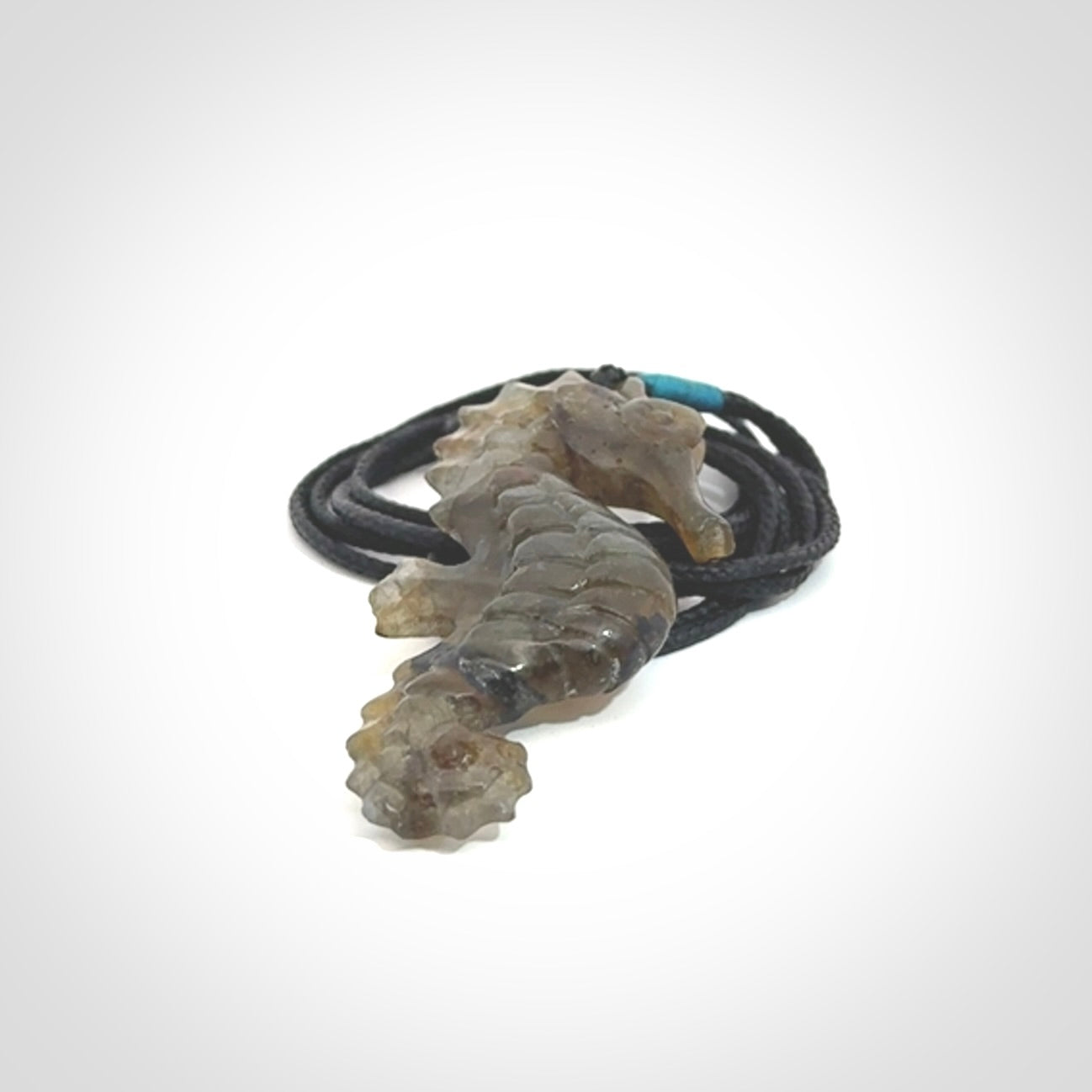 A hand carved labradorite seahorse pendant. We have carved this from beautiful labradorite and we bind them with our hand-plaited cords. The cords are a waxed polyester so they are durable and strong. We ship these worldwide with express courier anywhere in the world.