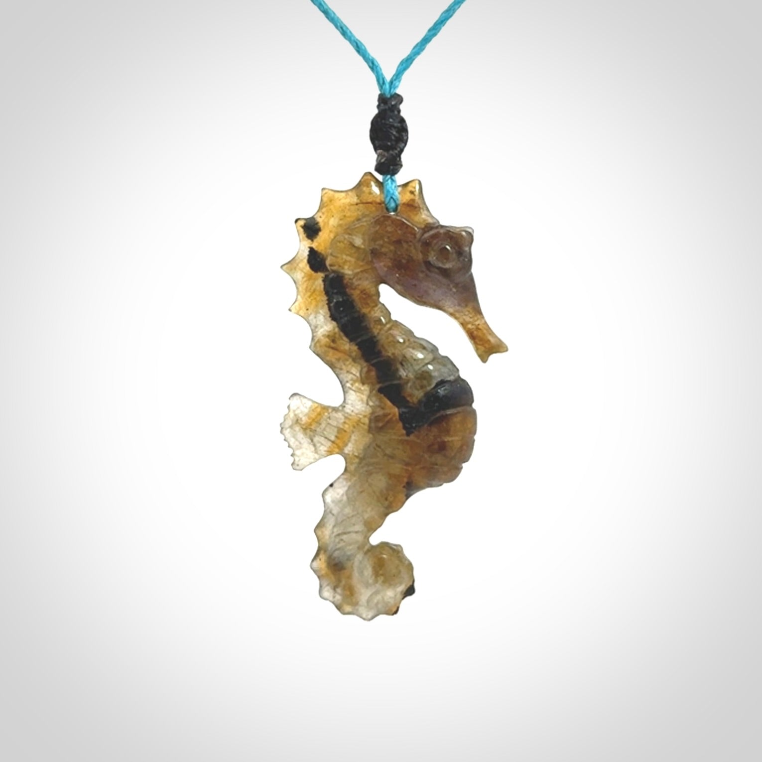 A hand carved labradorite seahorse pendant. We have carved this from beautiful labradorite and we bind them with our hand-plaited cords. The cords are a waxed polyester so they are durable and strong. We ship these worldwide with express courier anywhere in the world.