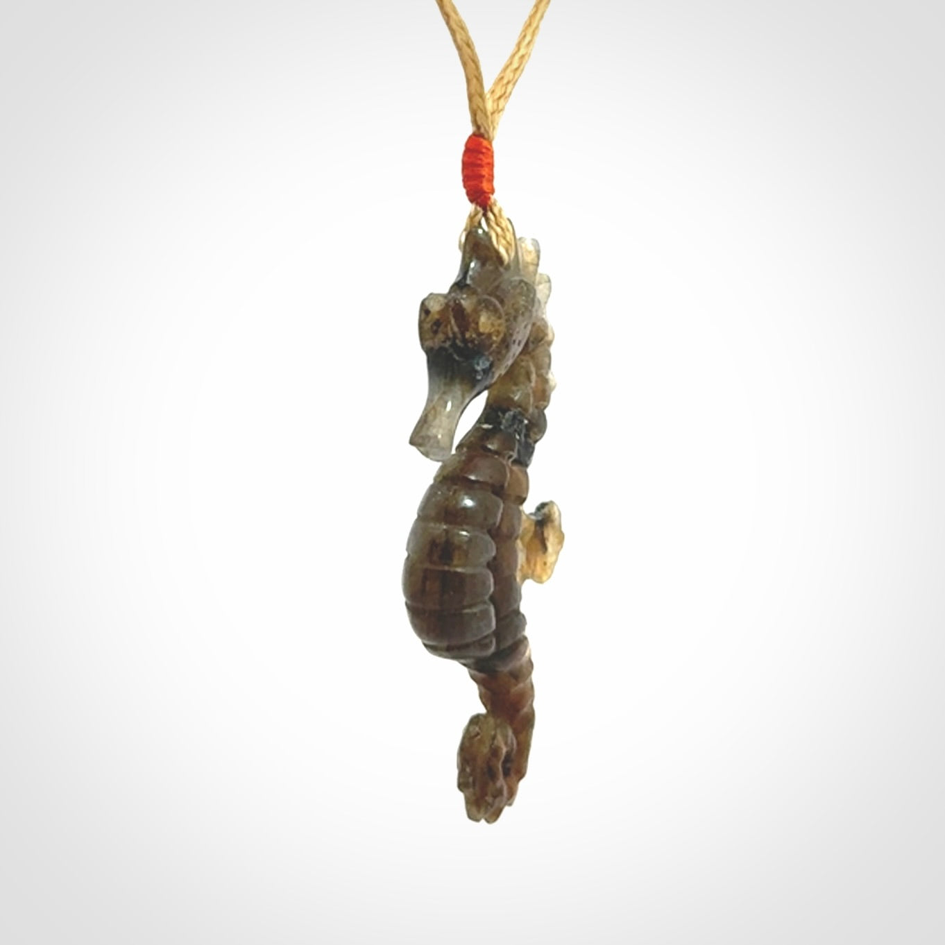 A hand carved labradorite seahorse pendant. We have carved this from beautiful labradorite and we bind them with our hand-plaited cords. The cords are a waxed polyester so they are durable and strong. We ship these worldwide with express courier anywhere in the world.