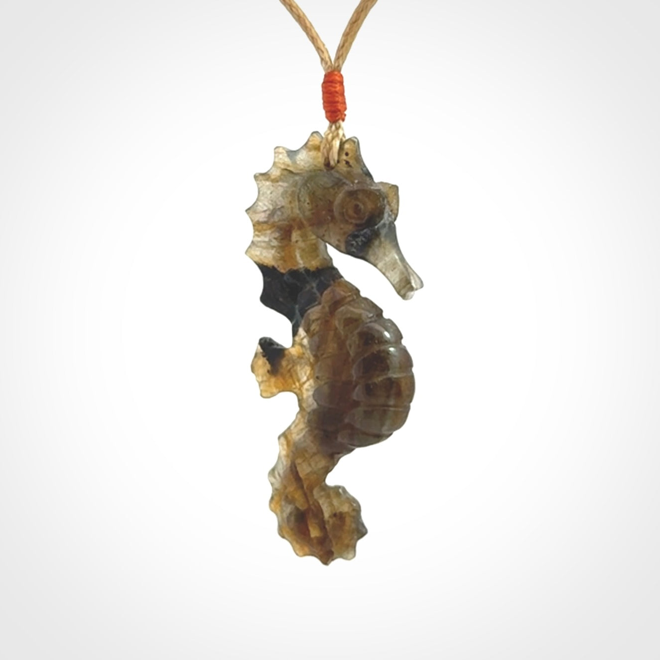 A hand carved labradorite seahorse pendant. We have carved this from beautiful labradorite and we bind them with our hand-plaited cords. The cords are a waxed polyester so they are durable and strong. We ship these worldwide with express courier anywhere in the world.