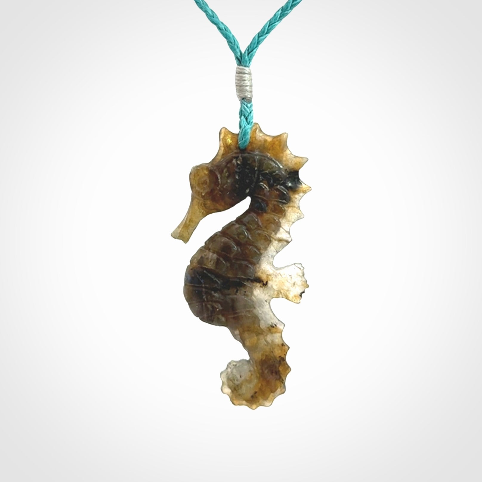 A hand carved labradorite seahorse pendant. We have carved this from beautiful labradorite and we bind them with our hand-plaited cords. The cords are a waxed polyester so they are durable and strong. We ship these worldwide with express courier anywhere in the world.