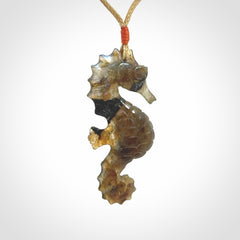 A hand carved labradorite seahorse pendant. We have carved this from beautiful labradorite and we bind them with our hand-plaited cords. The cords are a waxed polyester so they are durable and strong. We ship these worldwide with express courier anywhere in the world.