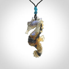 A hand carved labradorite seahorse pendant. We have carved this from beautiful labradorite and we bind them with our hand-plaited cords. The cords are a waxed polyester so they are durable and strong. We ship these worldwide with express courier anywhere in the world.